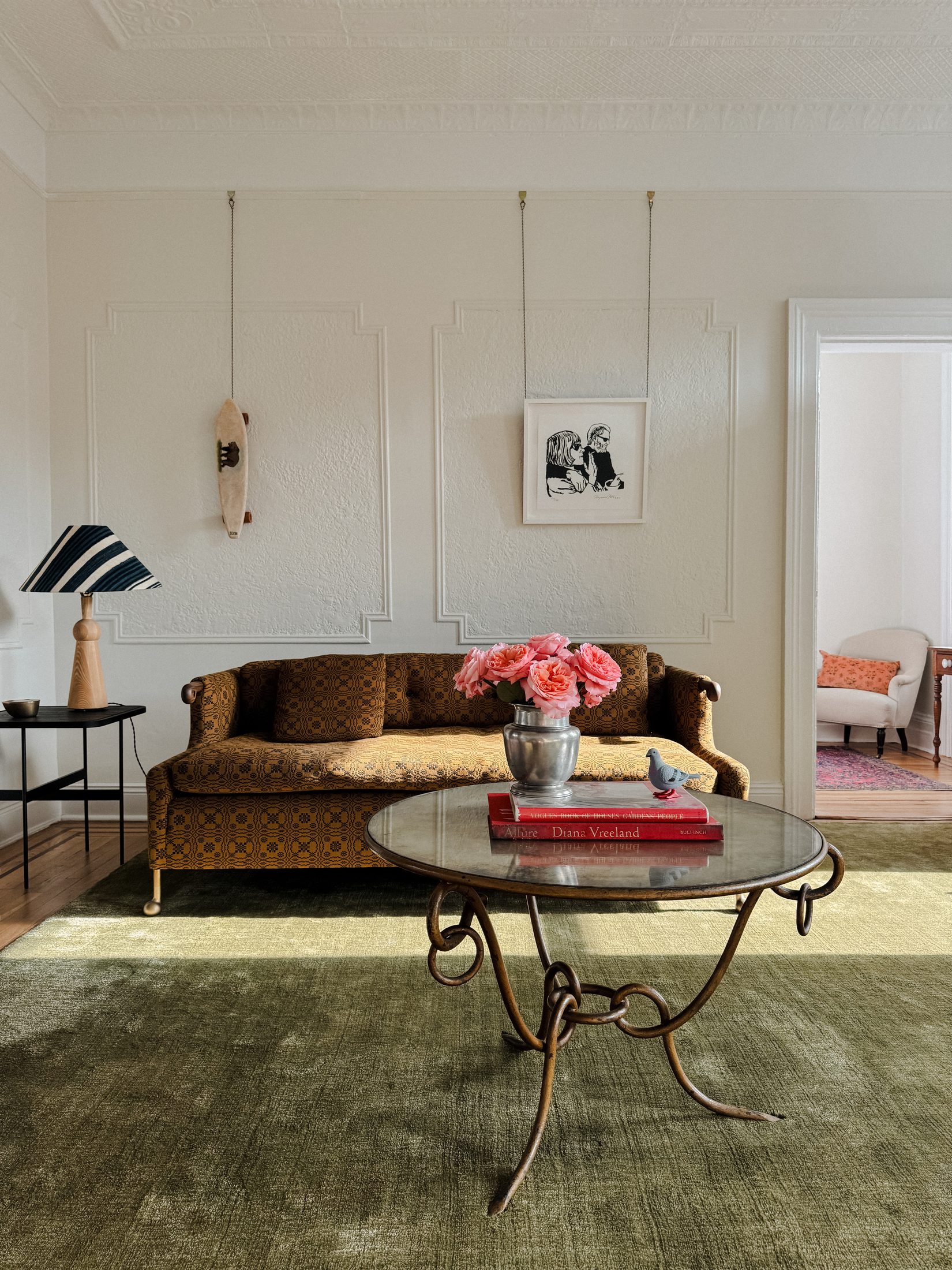 Interior with mustard sofa and green rug