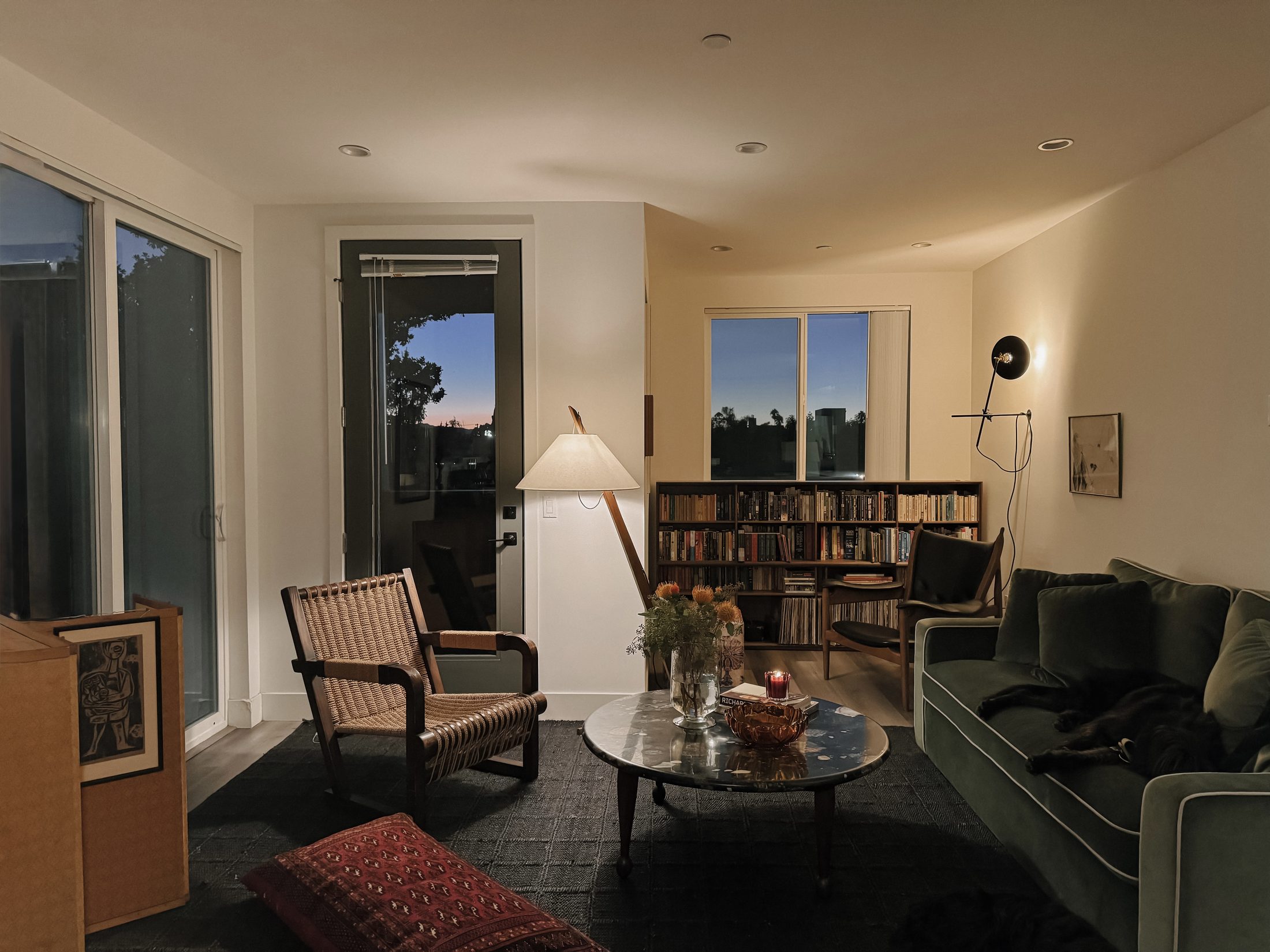 Evening living room with green velvet sofa